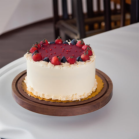 LiTY cake stand next to utensils demonstrating 12-inch scale and capacity