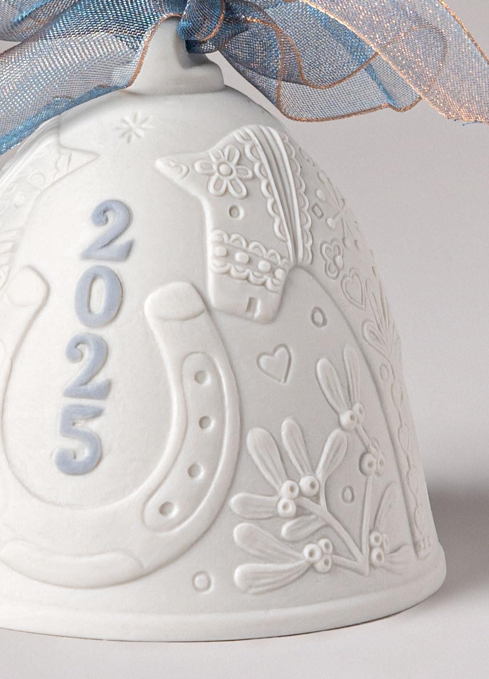 LLADRÓ detail of blue motif on bell emphasizing delicate painted accents