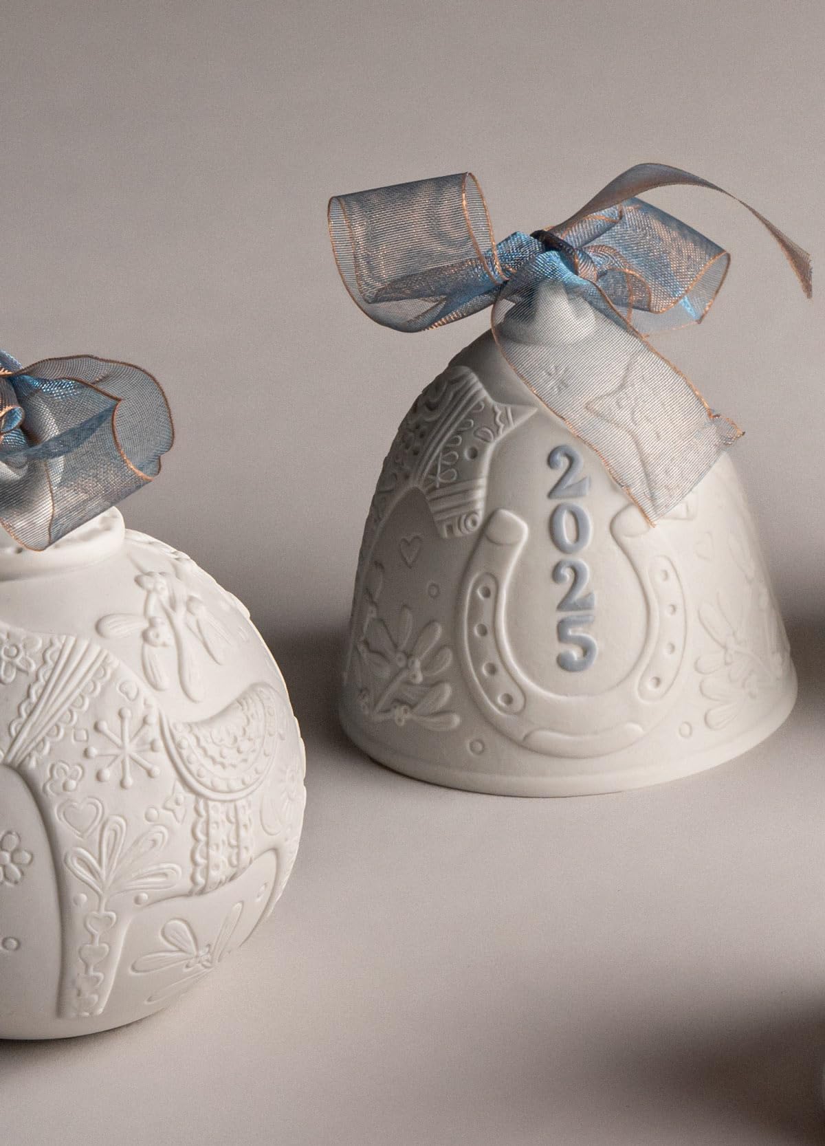 LLADRÓ bell on a mantel illustrating elegant holiday styling and visual impact