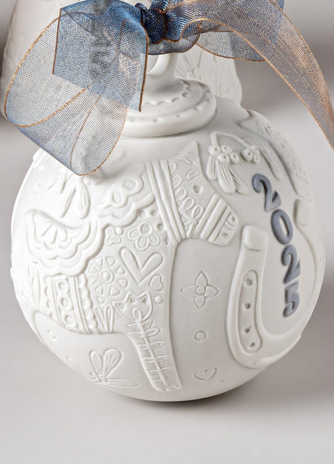 LLADRÓ detail of hand-painted blue accents showing artisan precision and beauty