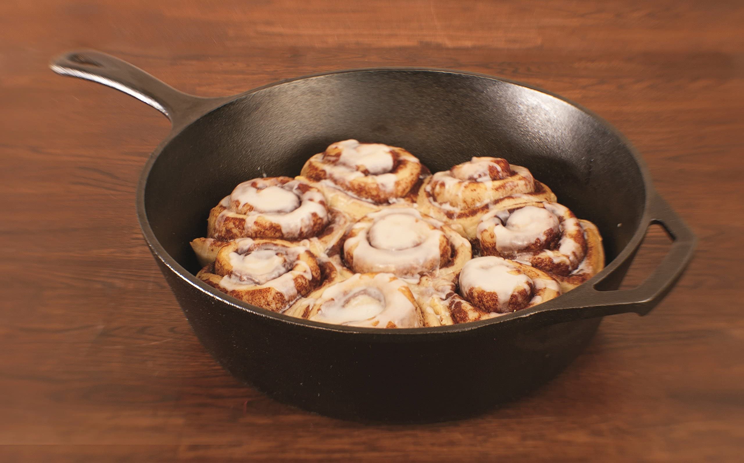 Lodge skillet in oven with baked dish demonstrating even browning and heat retention