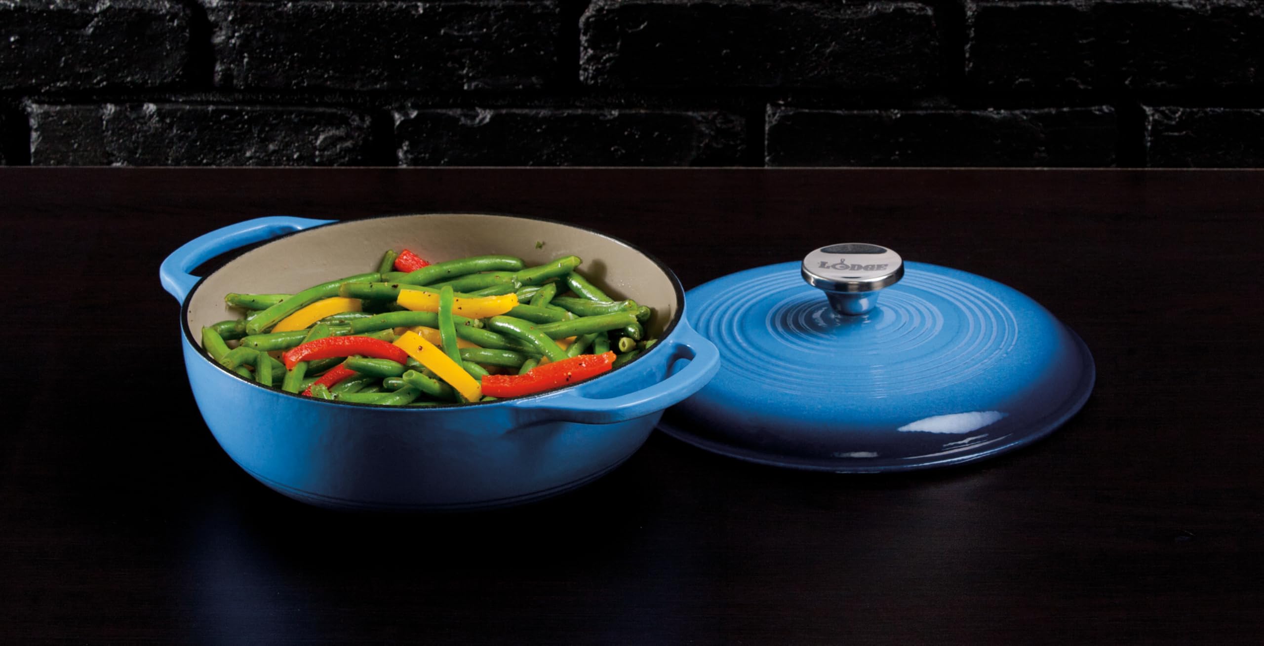 Lodge Dutch Oven in kitchen setting with food, demonstrating serving-ready appearance and oven-to-table convenience
