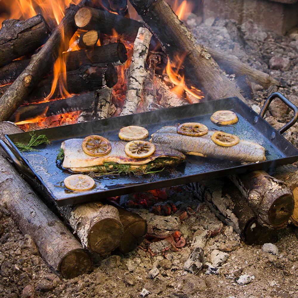 Lodge griddle in use with pancakes and eggs demonstrating even browning and fast heating