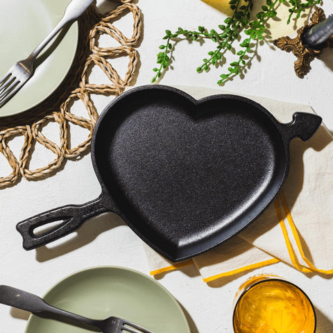 Lodge heart skillet next to measuring tape showing 8.5-inch size and portion scale