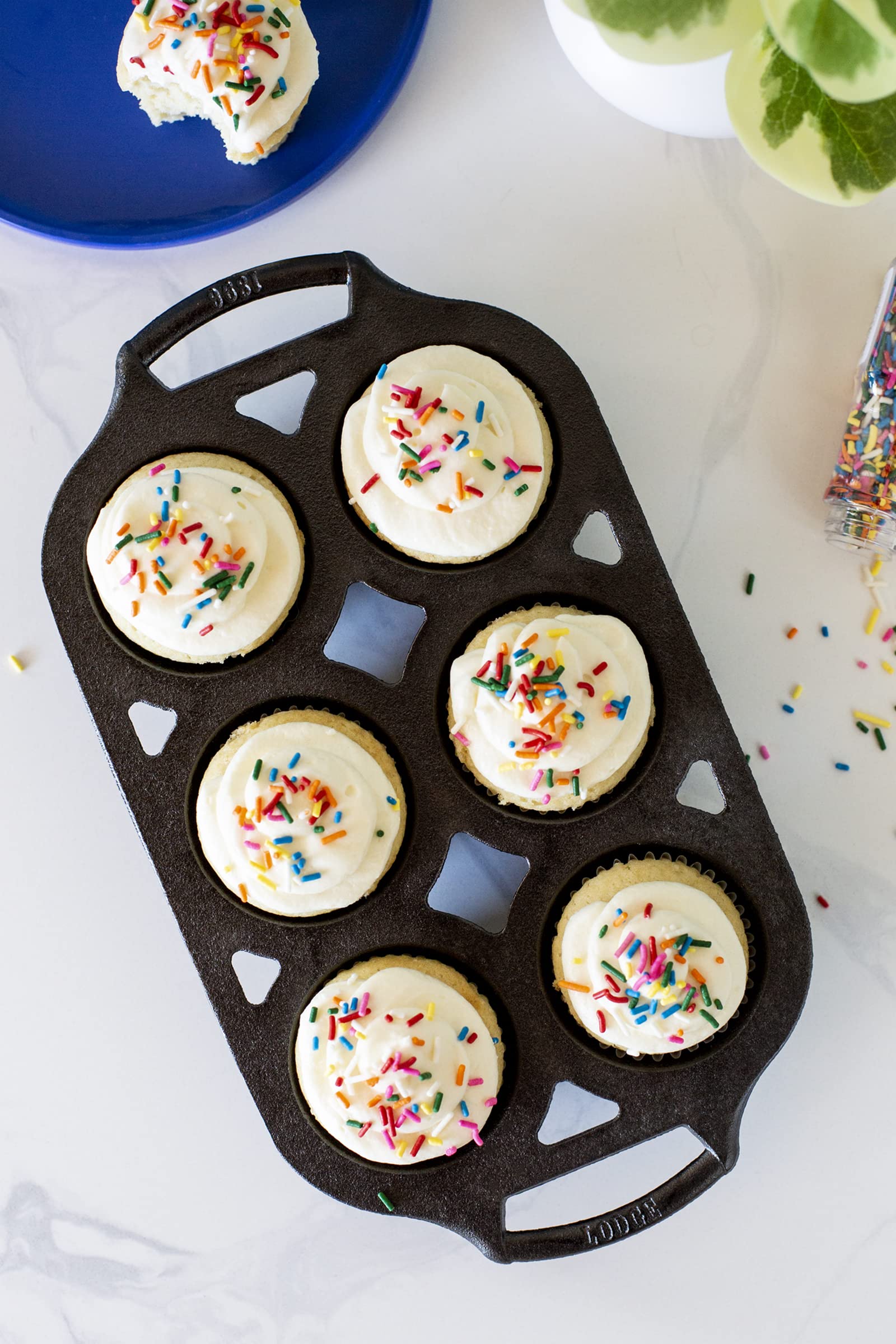 Lodge muffin pan beside hand for scale showing compact, space-saving benefit