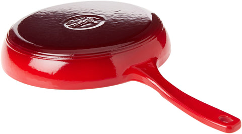 Lodge skillet next to a plate illustrating 11-inch size and serving benefit