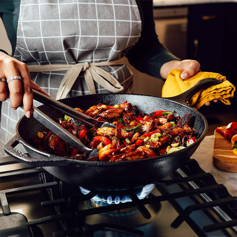 Lodge wok in use stir-frying vegetables to show even heat retention and sear