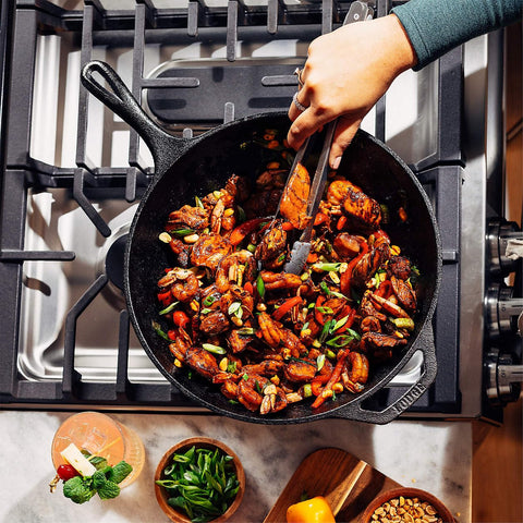 Lodge wok size comparison beside hand for scale and versatile kitchen fit