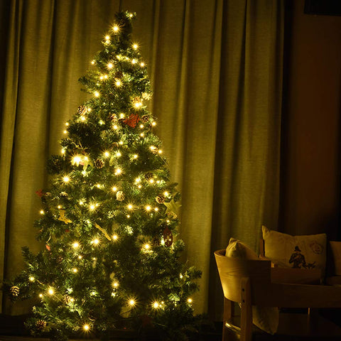 LOENDE string lights wrapped around a Christmas tree, warm glow creates cozy ambience