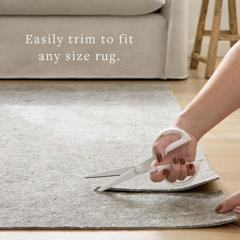 loloi rug pad placed under rug edge showing secure anti-slip benefit