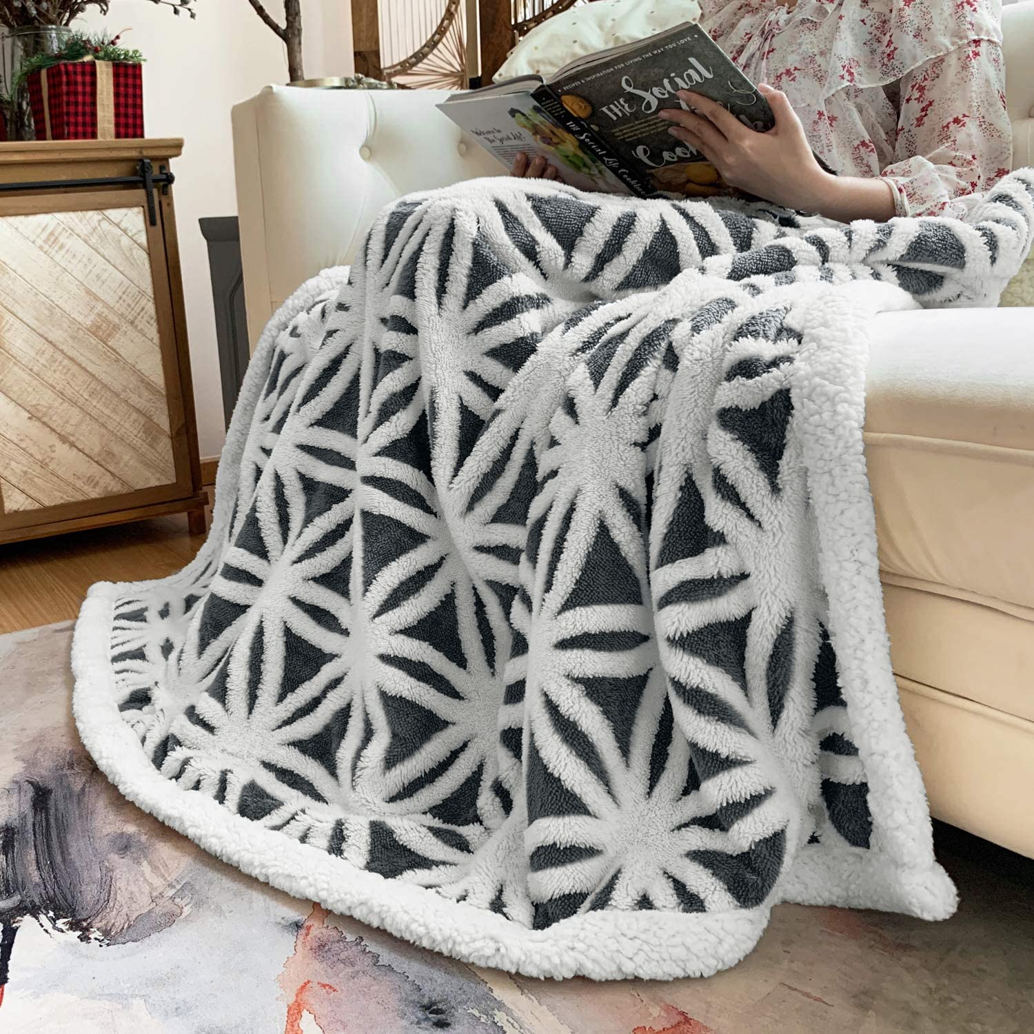 LOMAO blanket beside a book for size comparison showing generous 51x63 inch coverage