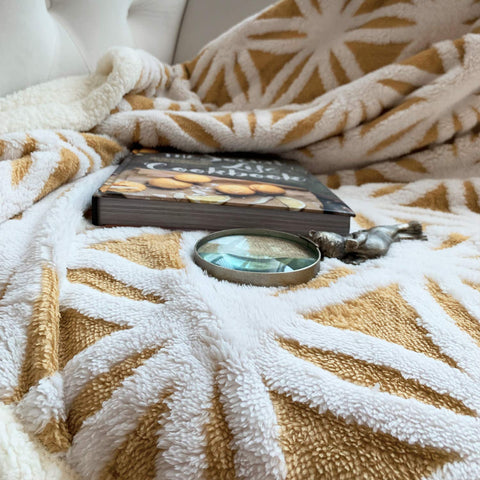 LOMAO throw draped on a sofa creating a cozy living room atmosphere