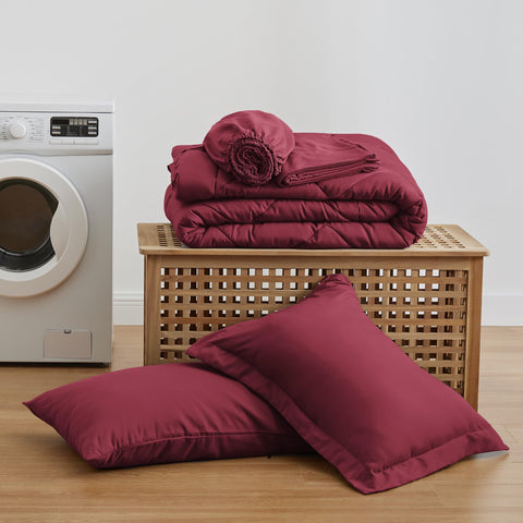 Love's cabin styled bedroom with burgundy set showing cozy, coordinated decor
