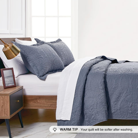 Love's cabin styled bedroom scene demonstrating the coverlet layered for decor