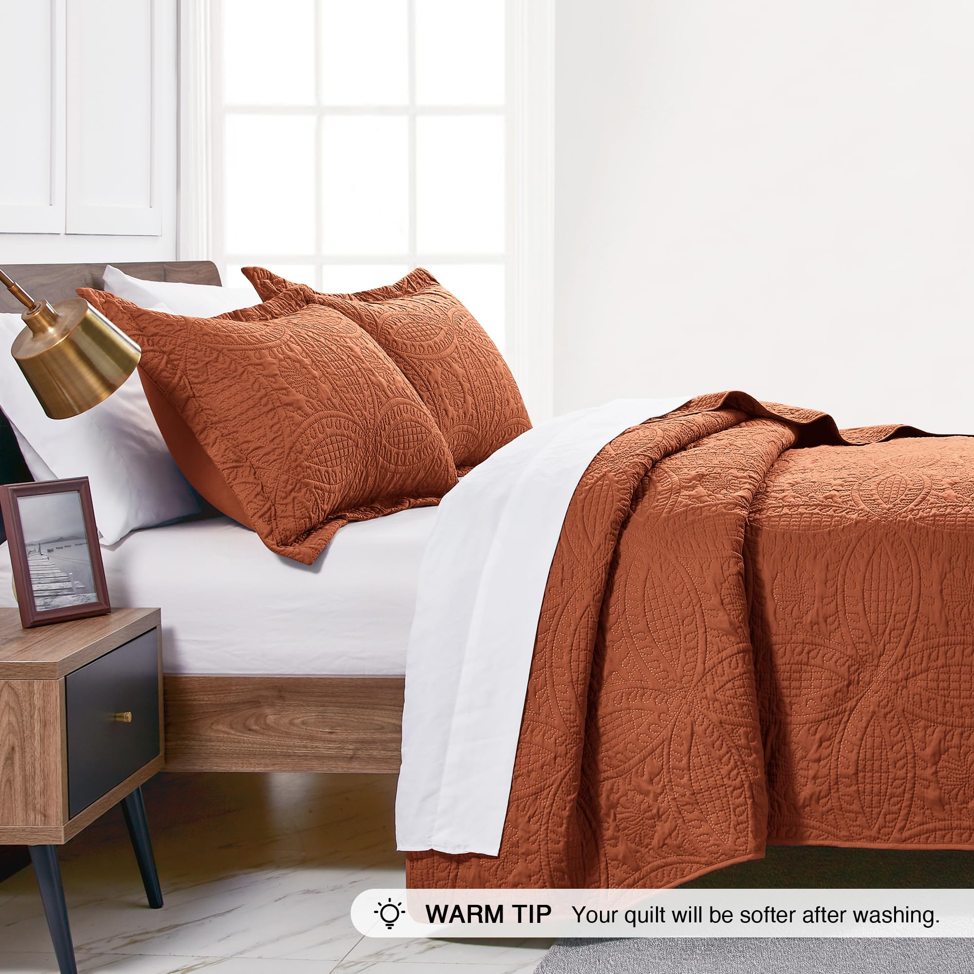 Love's cabin quilt styled on bed in umber demonstrating easy decor coordination