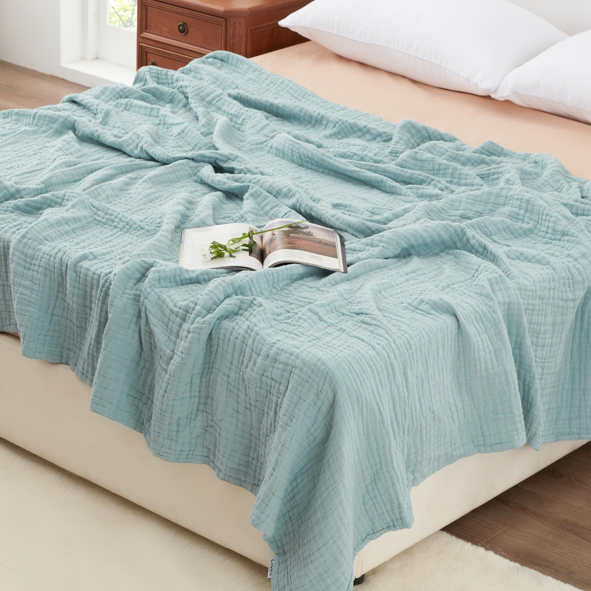 Love's cabin front view of cyan blanket showing full size and neat edges, adds cozy appeal