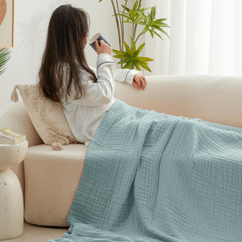 Love's cabin cyan blanket spread on queen bed, provides lightweight layered warmth