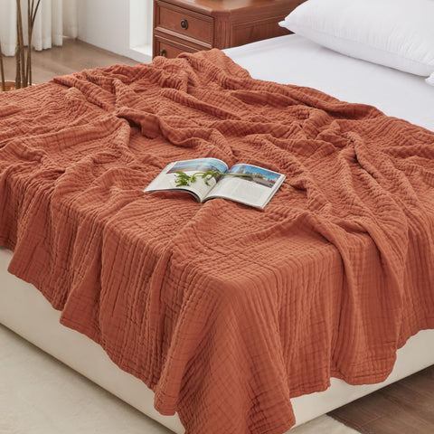 Love's cabin front view showing orange muslin blanket, adds warm decor