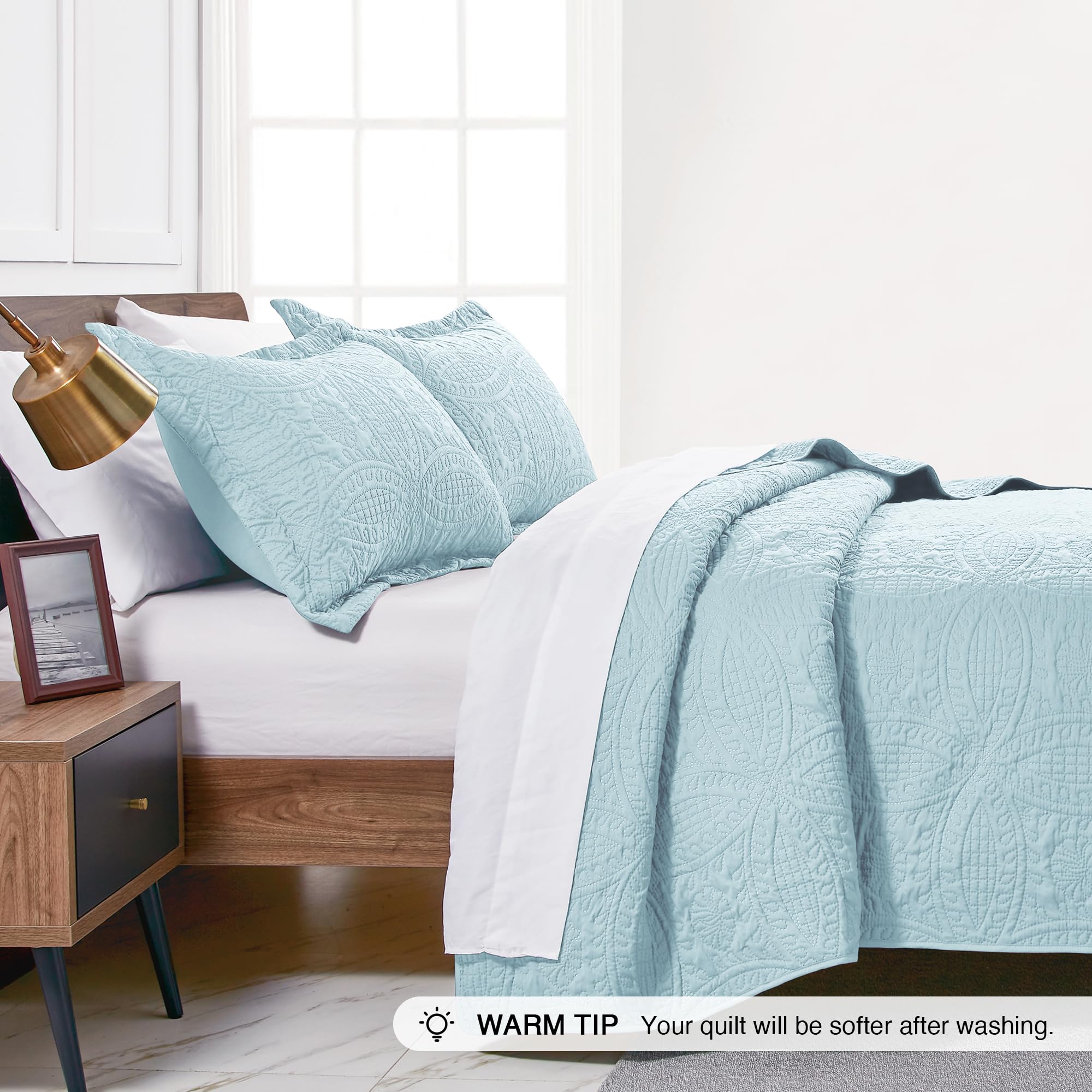 Love's cabin quilt styled on bed in a modern bedroom, easy-to-style benefit