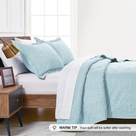 Love's cabin quilt styled on bed in a modern bedroom, easy-to-style benefit