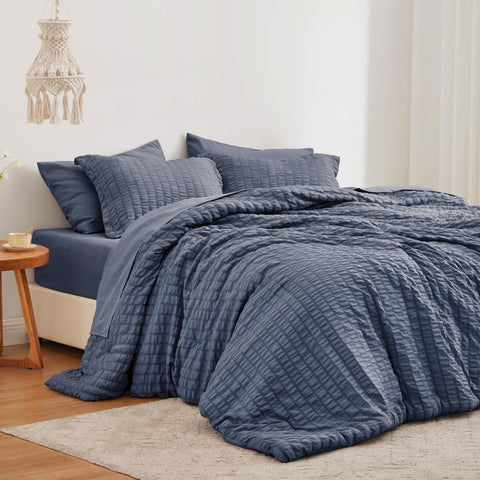 Love's cabin front view of navy seersucker comforter showing elegant styling and cozy look
