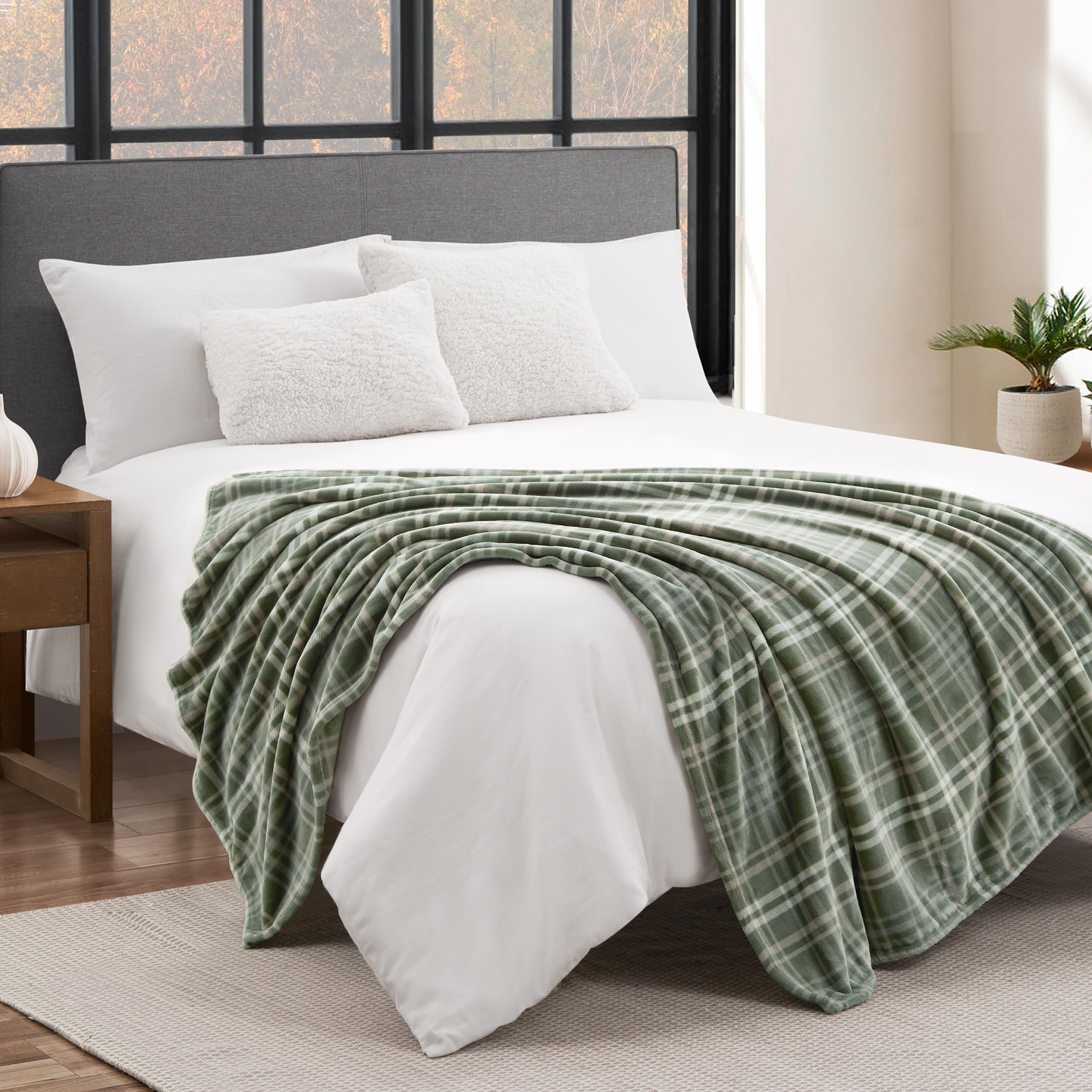 Lucky Brand throw beside a person illustrating 50x70 size for single-person coverage