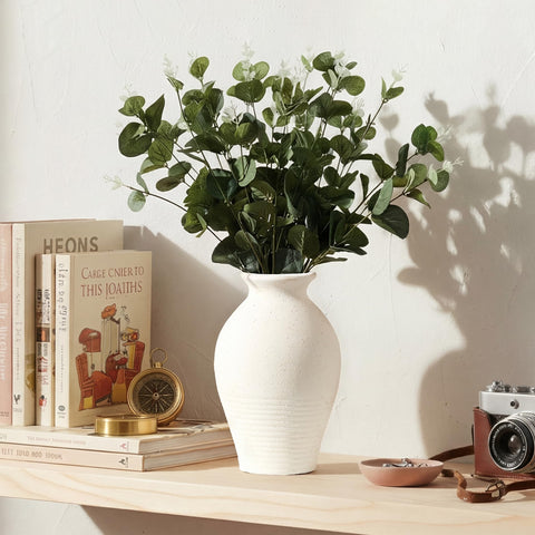 LUKA vase next to a book for scale showing compact, table-friendly size