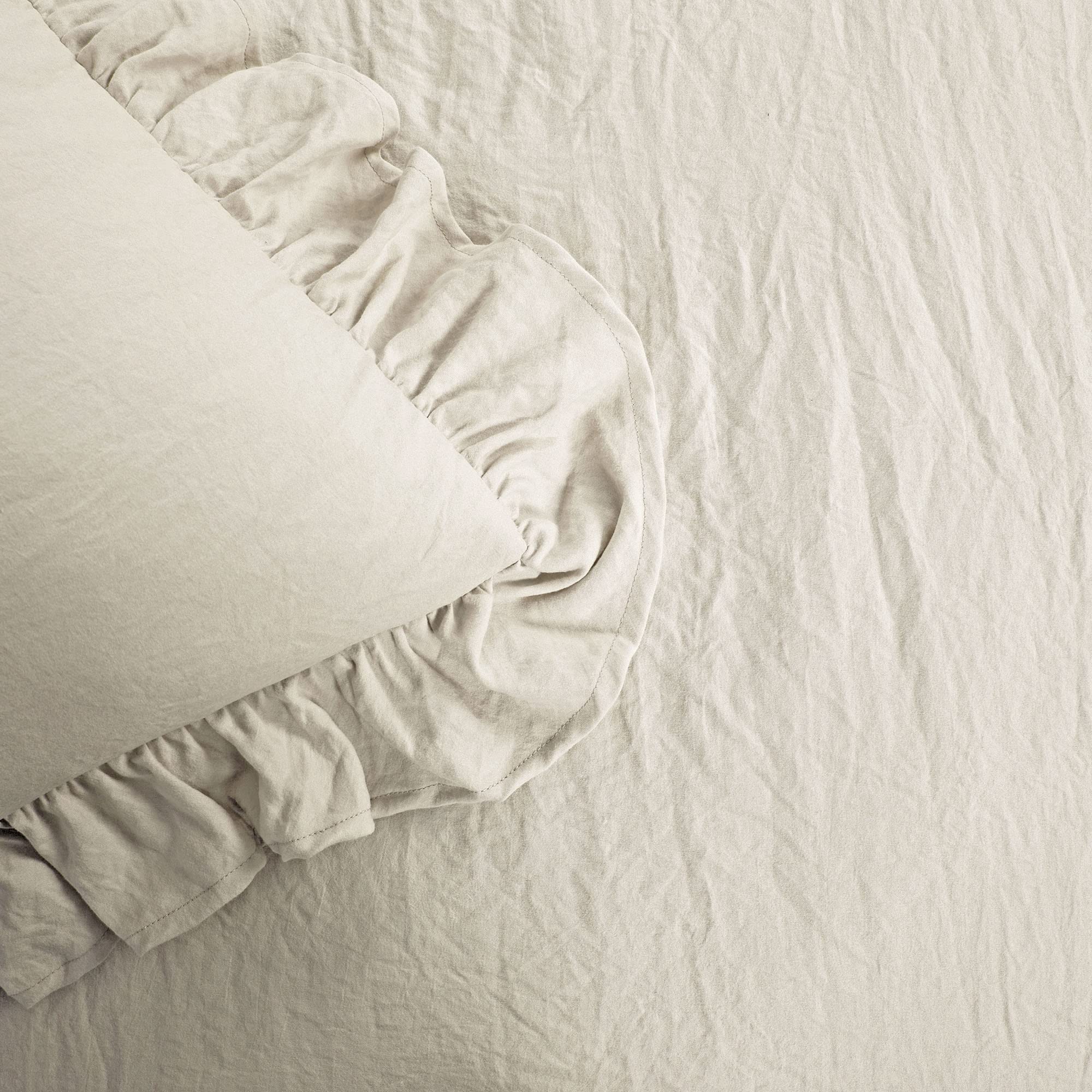 Lush Decor Reyna styled on a bed in a farmhouse room showing calming neutral appeal