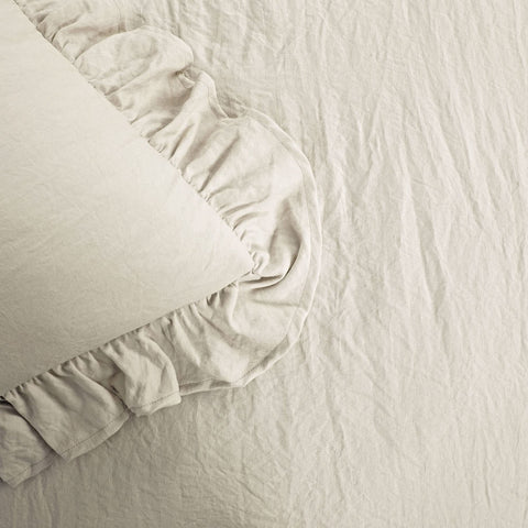 Lush Decor Reyna styled on a bed in a farmhouse room showing calming neutral appeal