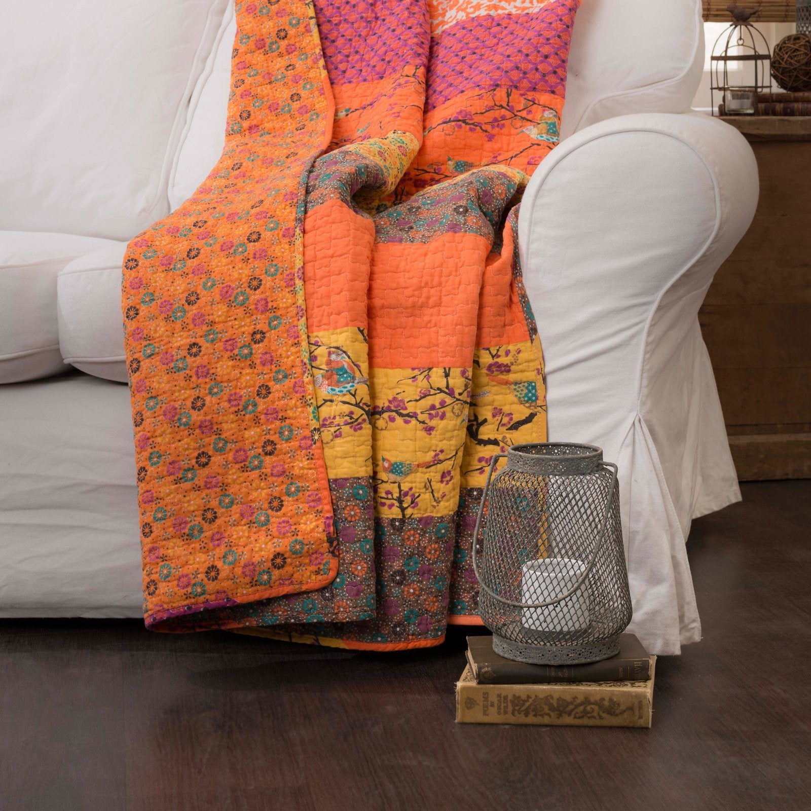 Lush Decor Royal Empire folded beside a seated person to show 50 by 60 inch scale and everyday comfort