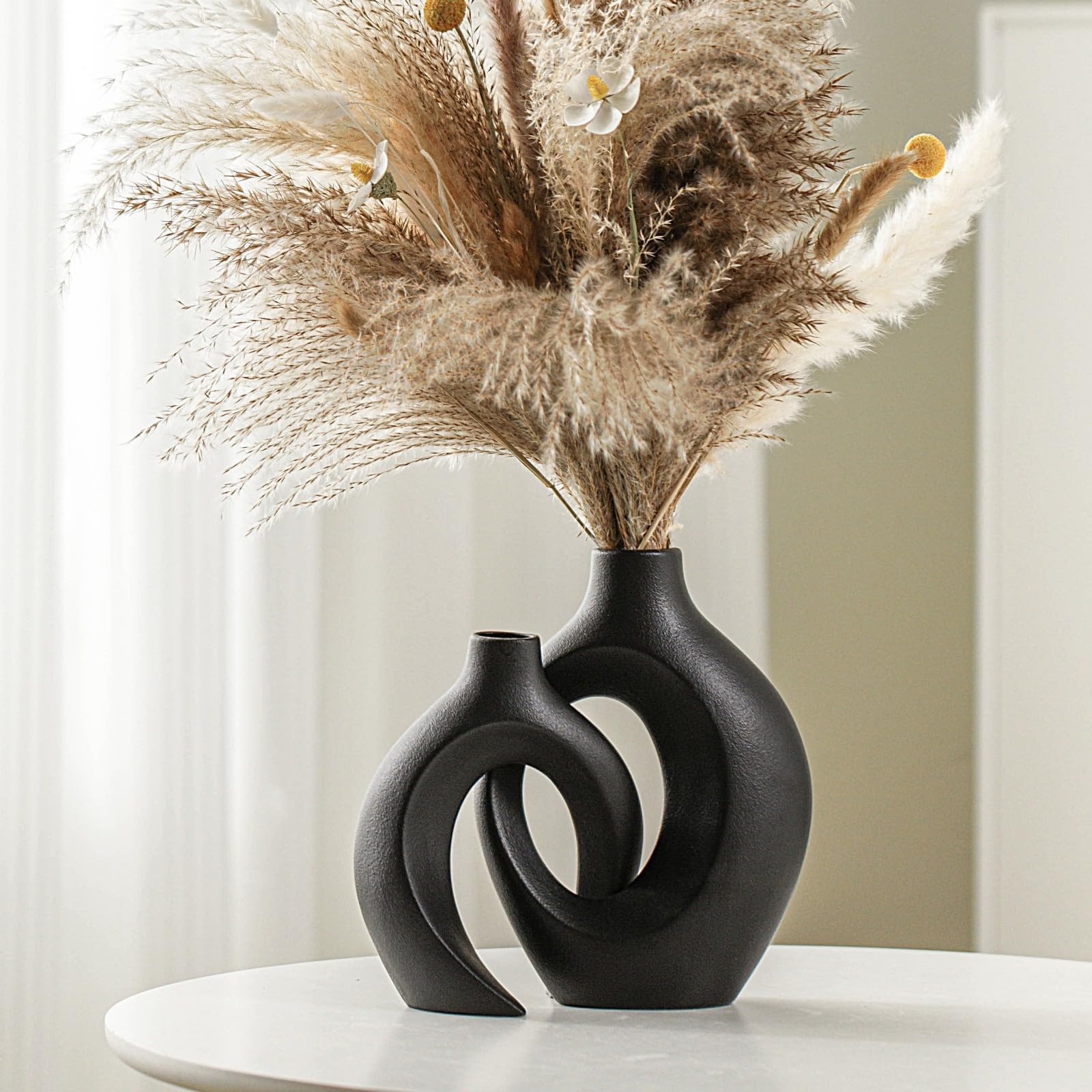 Lvases front view of two off-black snuggle hollow vases showing modern contrast and balance