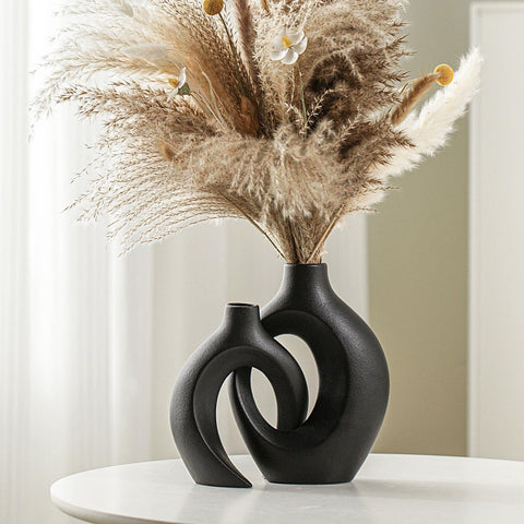 Lvases front view of two off-black snuggle hollow vases showing modern contrast and balance