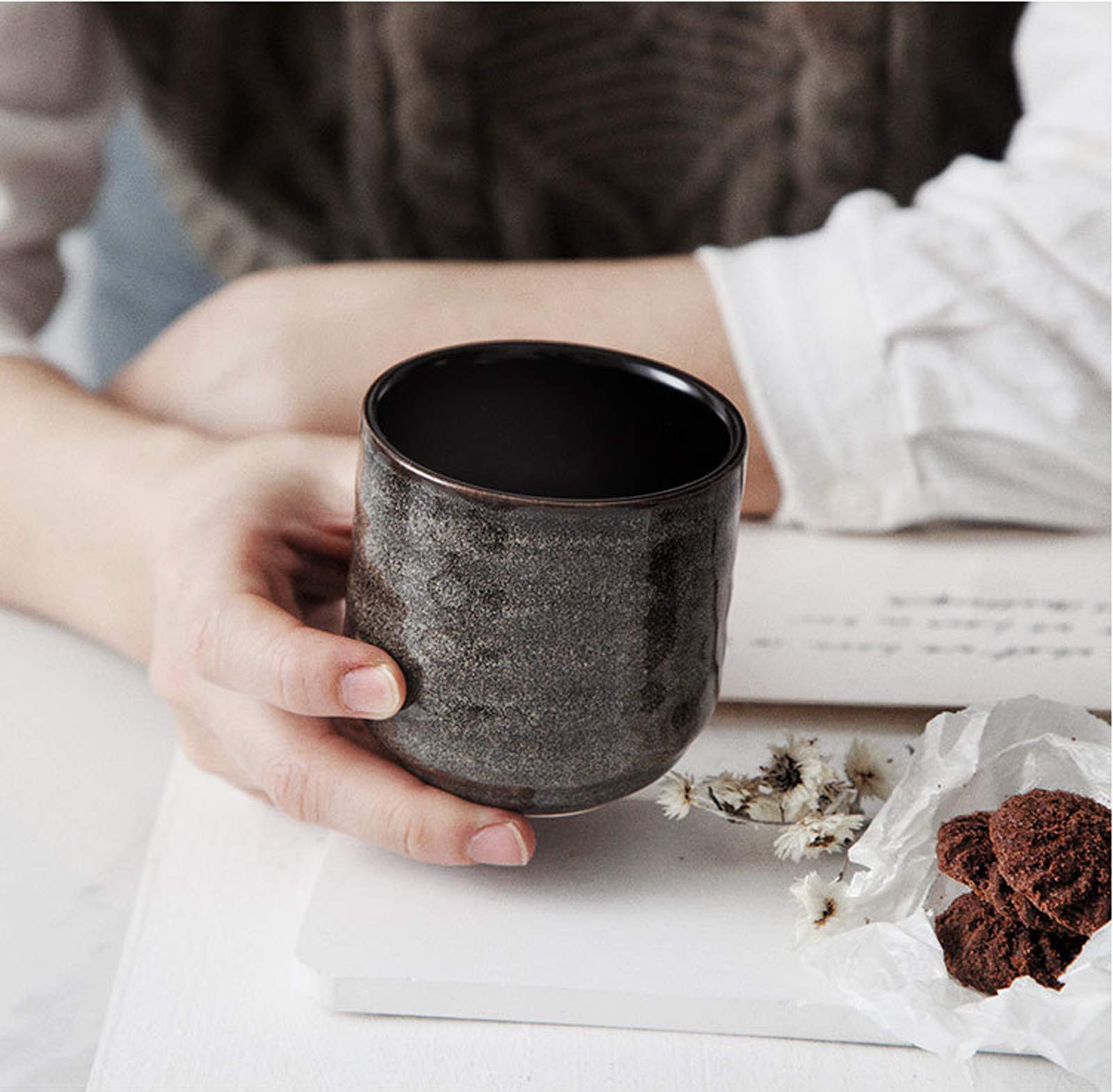 Lxuwbd cup held in hand to show 200ml scale and ergonomic balance