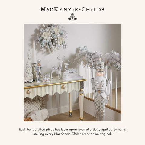 MACKENZIE-CHILDS scale comparison with hand showing compact display size