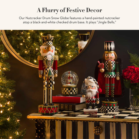 MACKENZIE-CHILDS close-up of nutcracker, teddy bear, and tiny gifts inside globe highlights fine detail