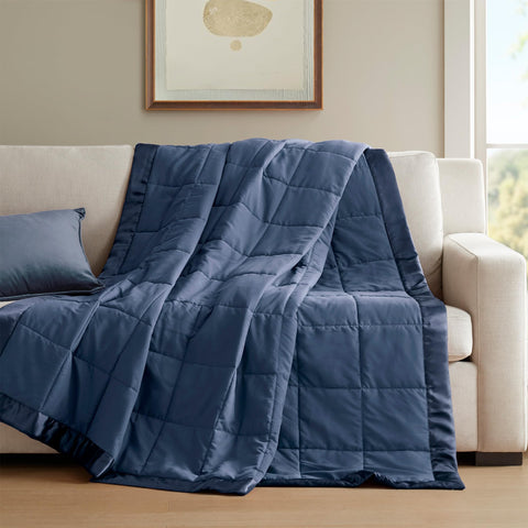 Madison Park navy blanket on twin bed styled in a bedroom for inviting layered look