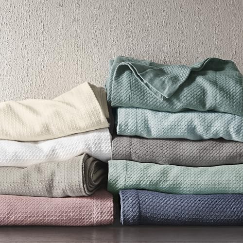 Madison Park blanket draped over sofa showing casual styling and cozy living room use