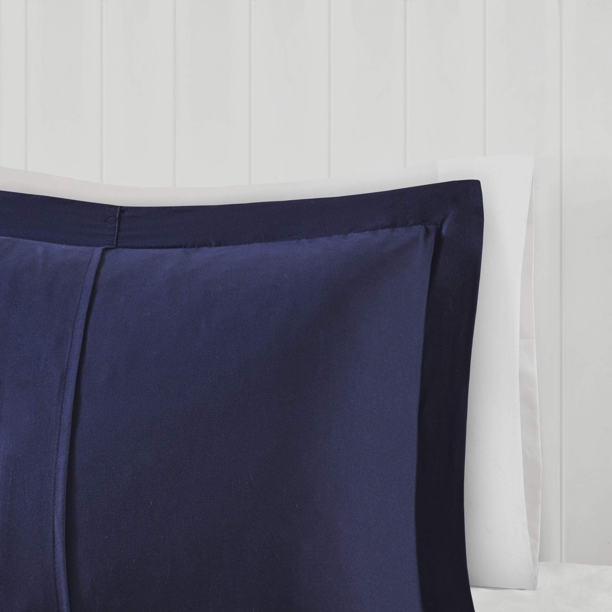 Madison Park comforter next to pillow showing twin size scale for dorm rooms