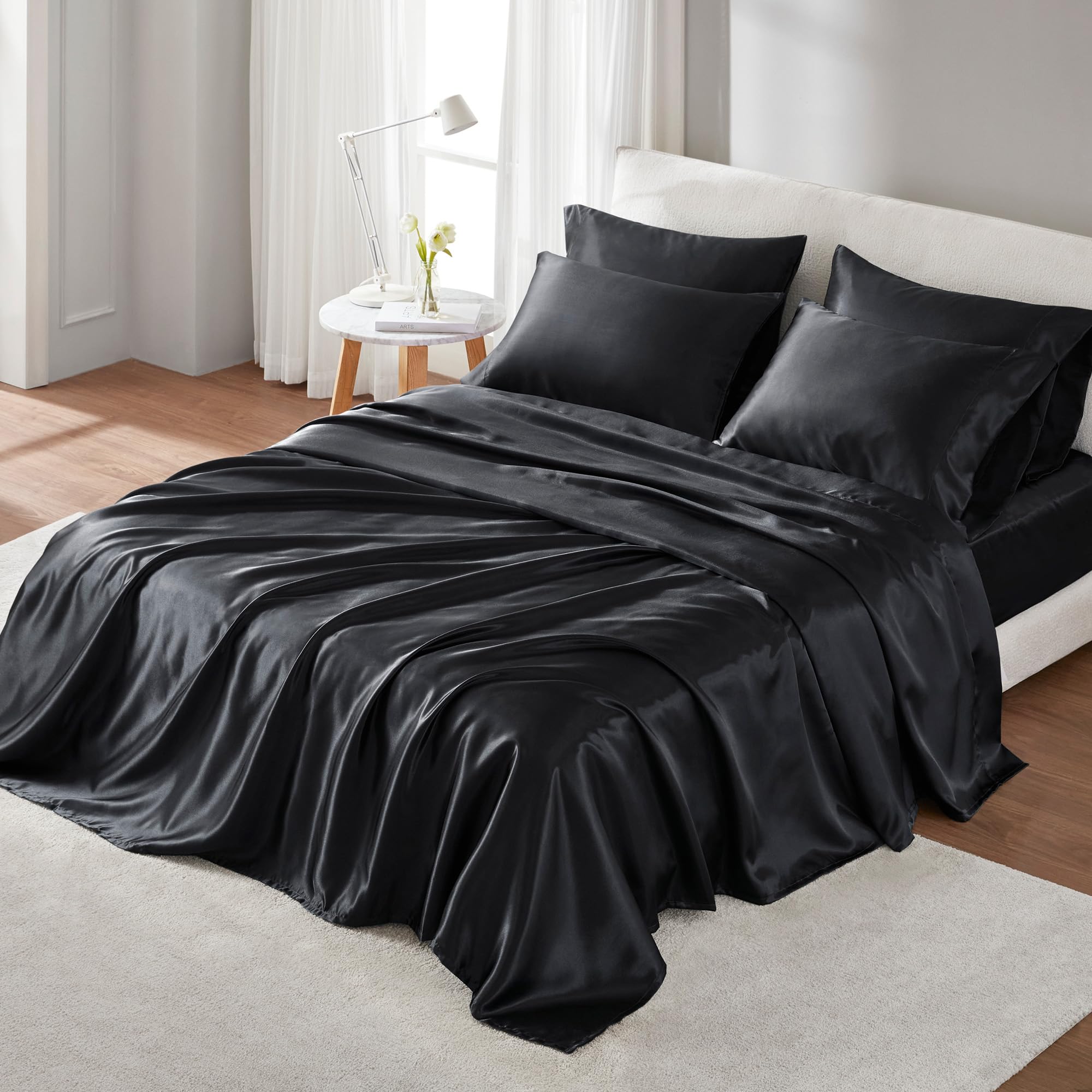Madison Park front packaging showing black satin sheet set and brand