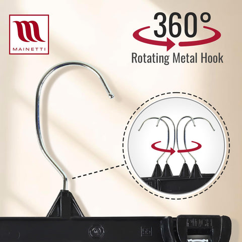 Mainetti black hangers arranged in a closet creating coordinated space-saving look