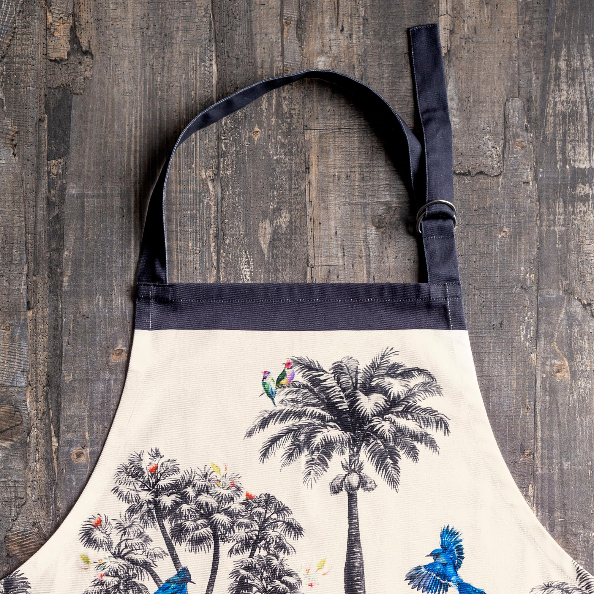 Maison d' Hermine apron worn by host in dining setting, elevates seasonal entertaining