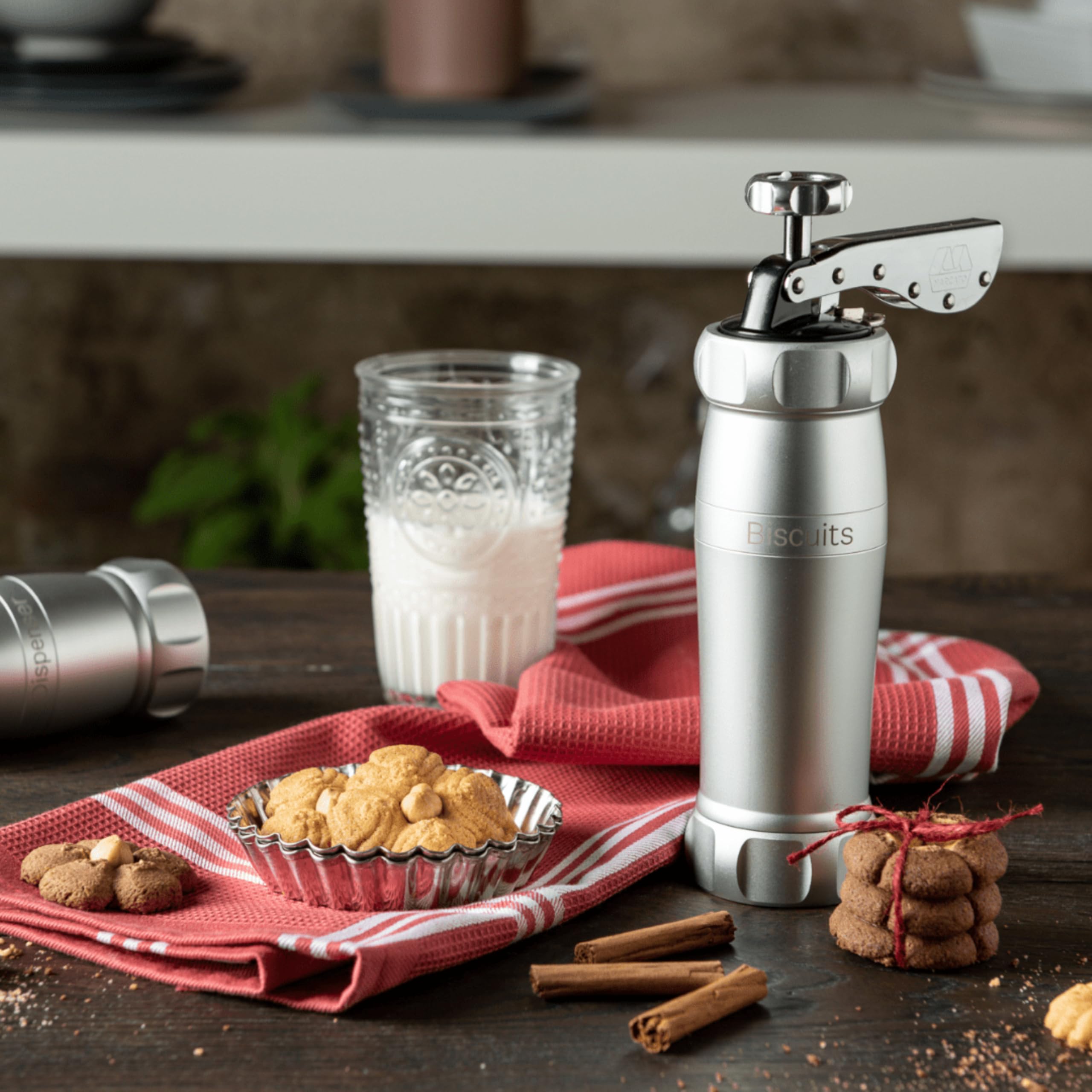 MARCATO cookie press held in hand to show scale and comfortable operation for home bakers