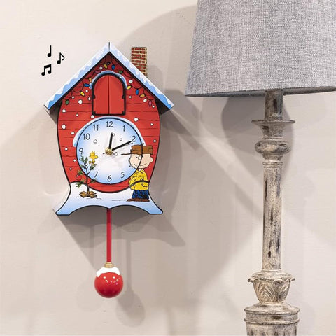 Mark Feldstein Peanuts clock on a mantel in holiday décor providing cheerful seasonal ambiance