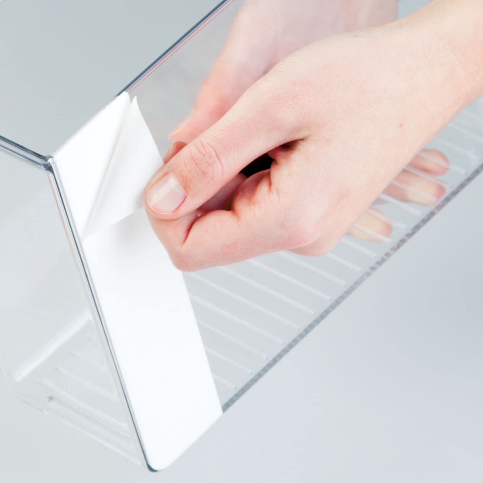 mDesign bin mounted under cabinet demonstrating space-saving benefit