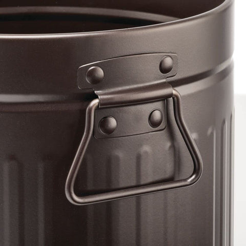 mDesign handles being used to carry the bin easily for quick emptying