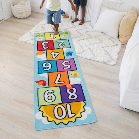 Melissa & Doug rug with child stepping on squares to show scale and encourage gross motor skills