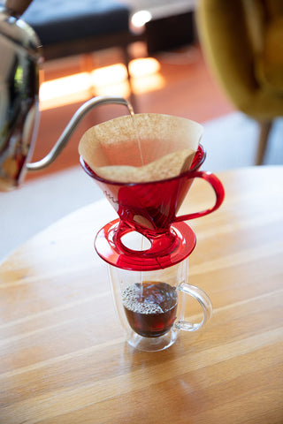 Melitta used filter and grounds in compost bin promoting eco-friendly disposal