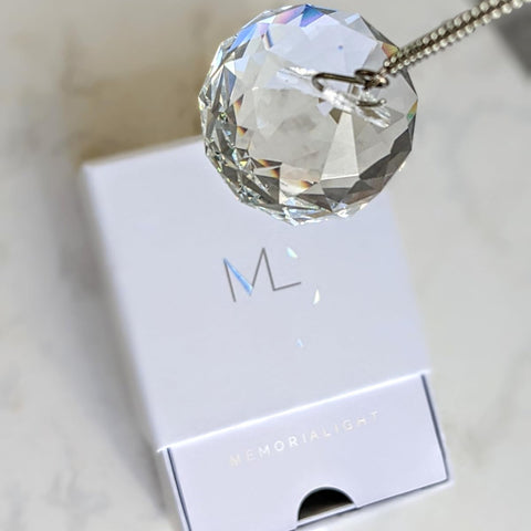 Memorialight held next to a hand for scale — Memorialight is compact and delicate yet meaningful