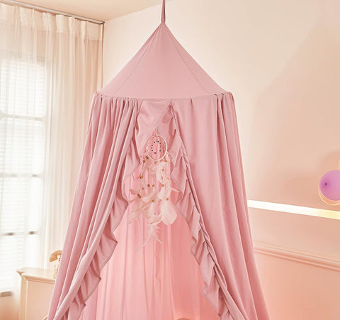 Mengersi canopy draped over a crib creating a cozy, private sleeping environment for baby