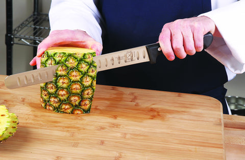 Mercer Culinary knife next to ruler showing 11-inch blade for scale and portioning